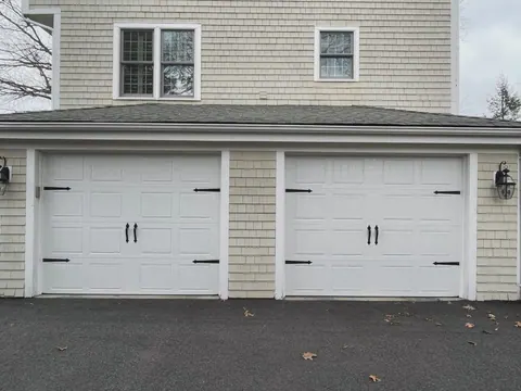 Two white carriage-style garage doors in Abington