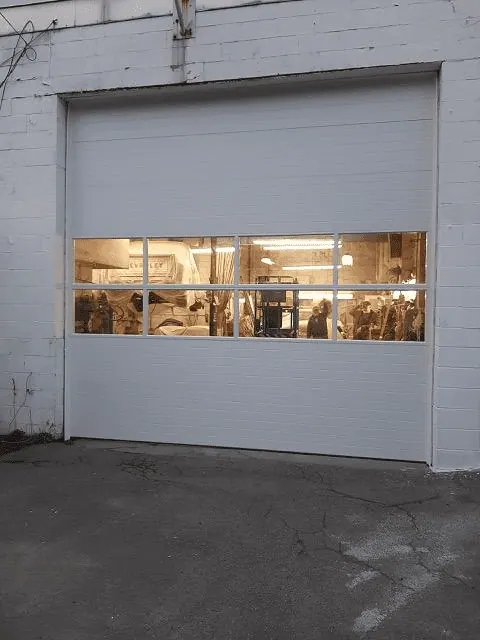Replacement overhead door with two window rows at an auto-body shop