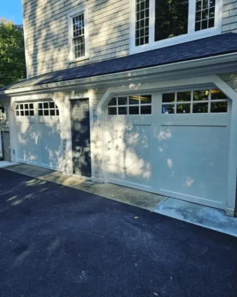 White carriage-style doors at the Norwell property