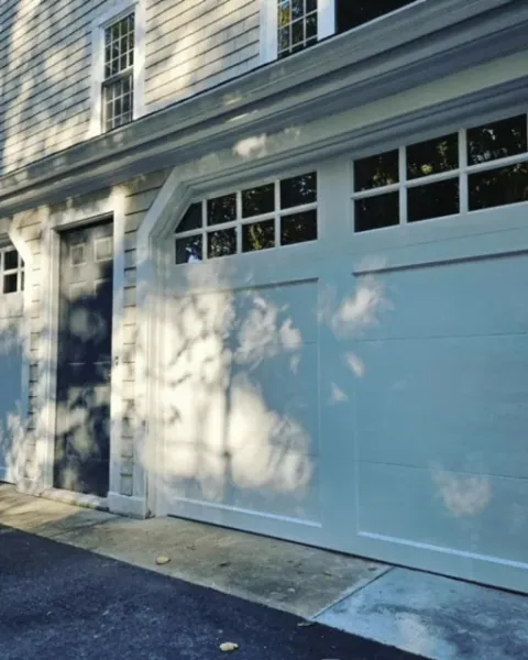 Closer view of carriage-style doors and windows in Norwell