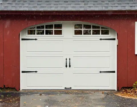 White carriage-style door beneath an arched opening