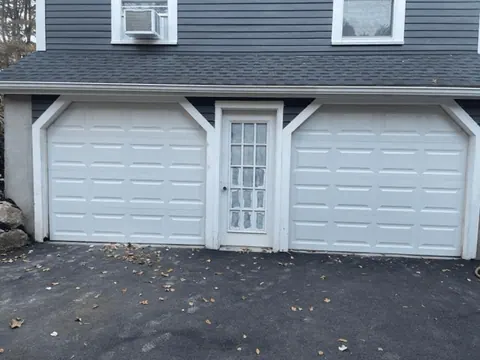 Two white short-panel replacement garage doors in Weymouth