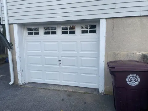 White short-panel garage door with windows in Weymouth