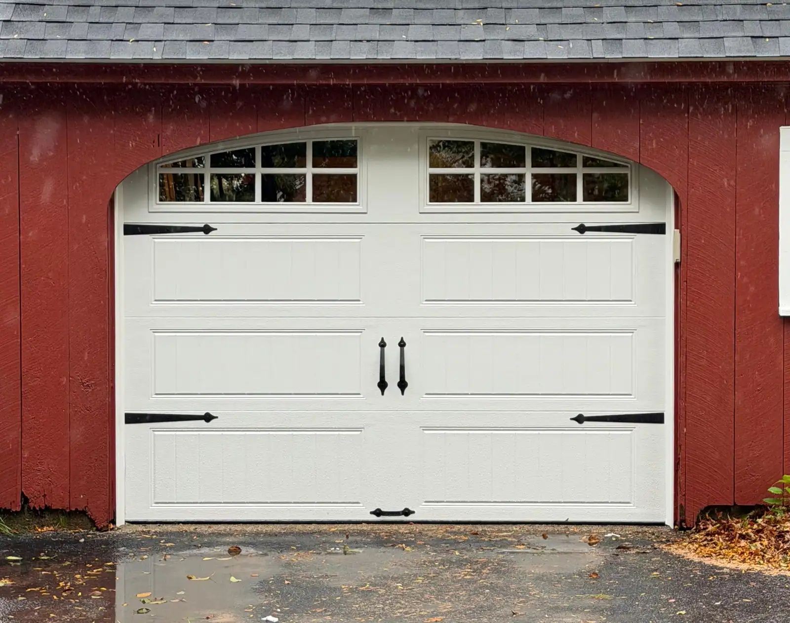 White carriage-style door beneath an arched opening